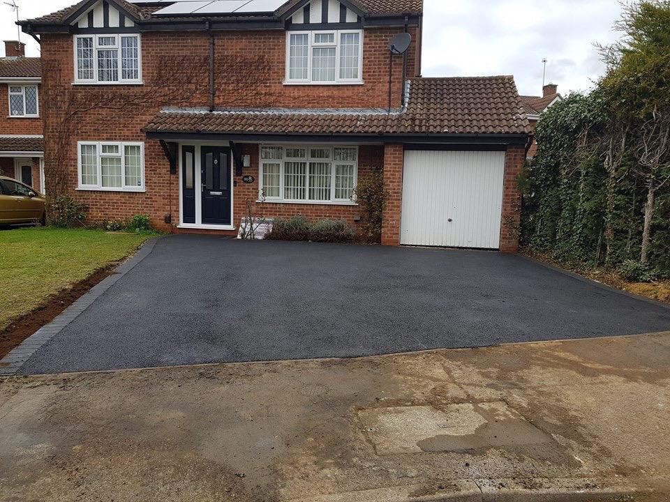 Finished tarmac driveway with block edging in front of a detached house