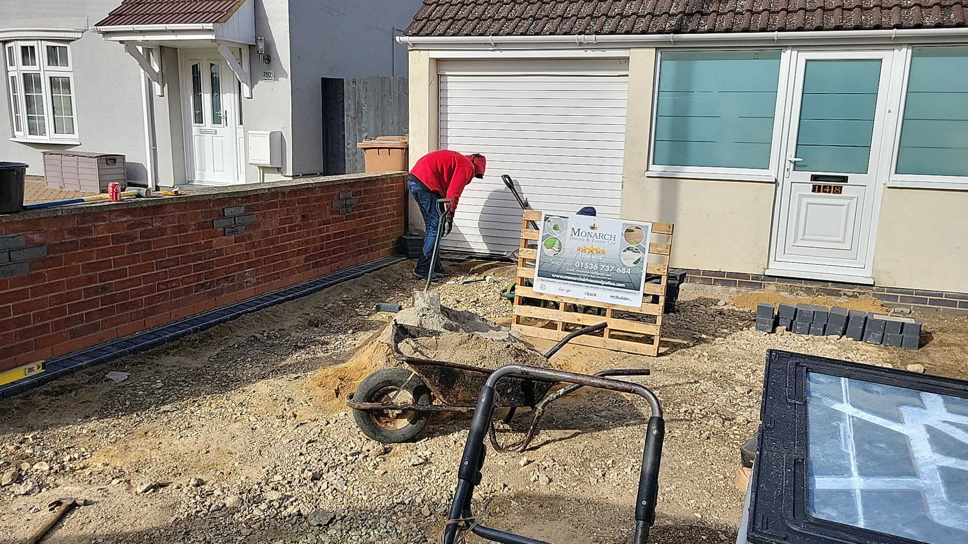 Front garden groundwork under way with a Monarch site board on a pallet