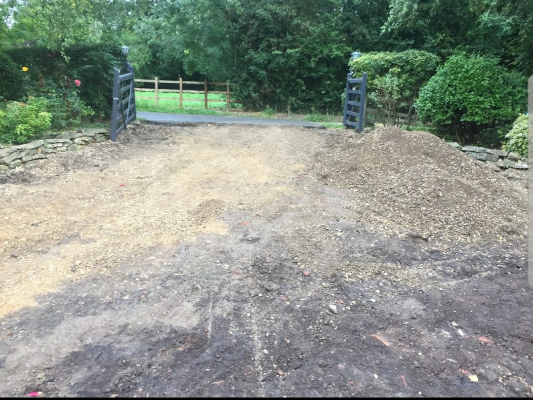 Gated driveway entrance dug out and ready for its new surface