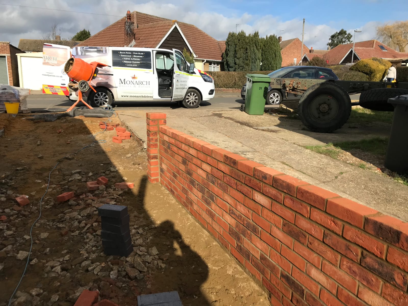New red brick boundary wall being built, with the Monarch van parked behind
