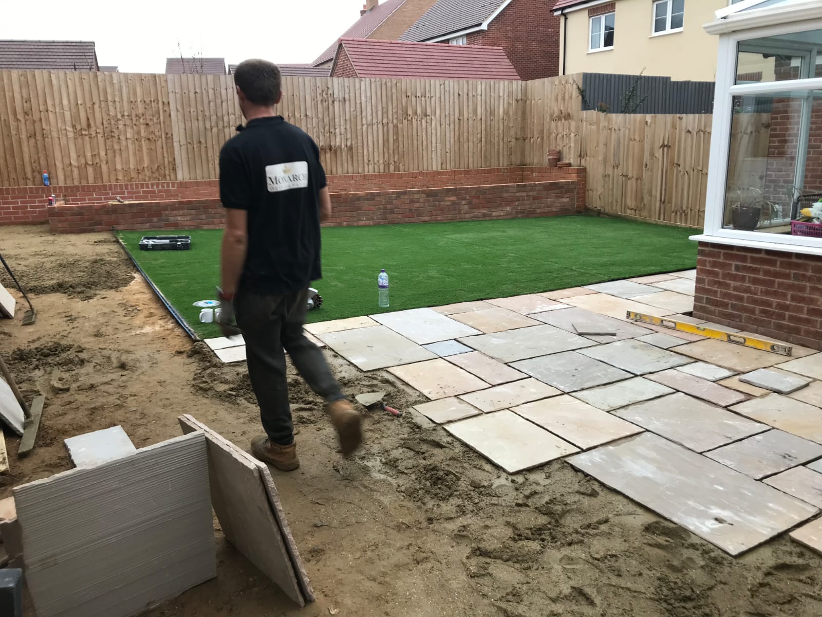 Natural stone patio slabs being laid in a back garden